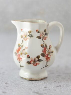 Pink floral white gold octagonal creamer with illegible marking 4" tall